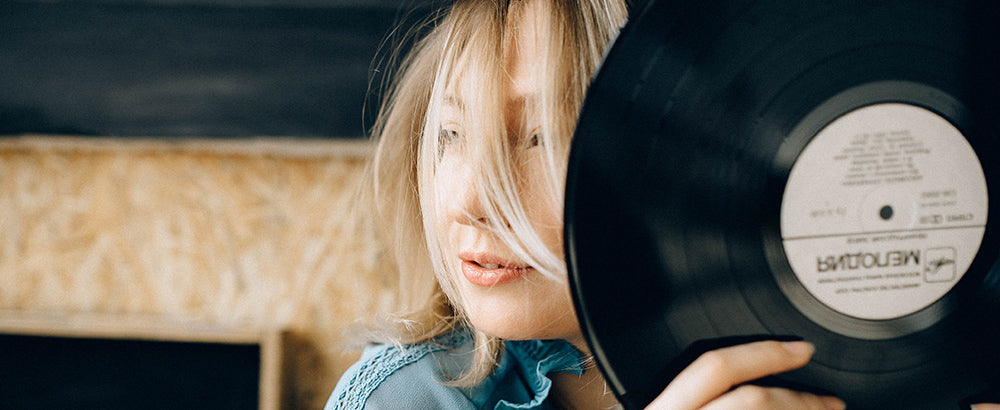 Woman holding a cleaned vinyl record